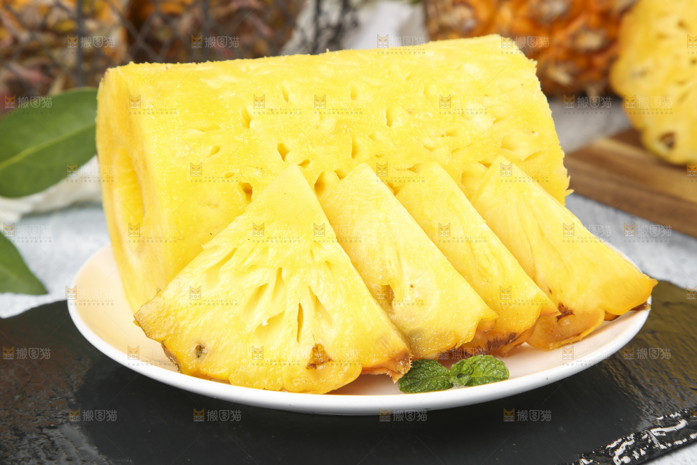 黑石板上放着一盘新鲜菠萝果肉