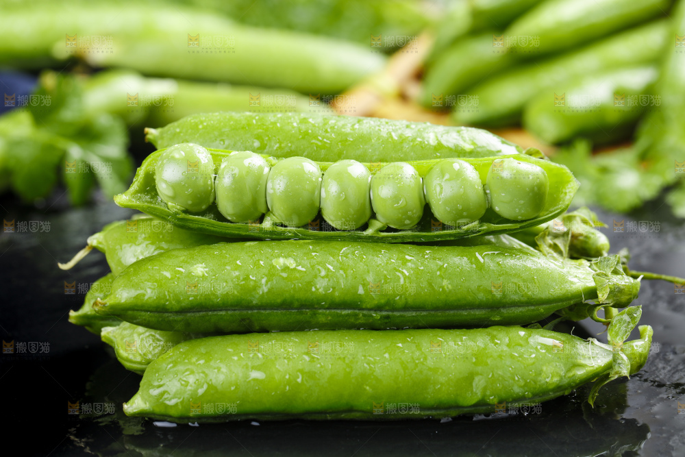 黑石板上堆放着甜豌豆