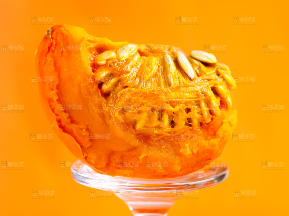 玻璃杯上放着红皮南瓜