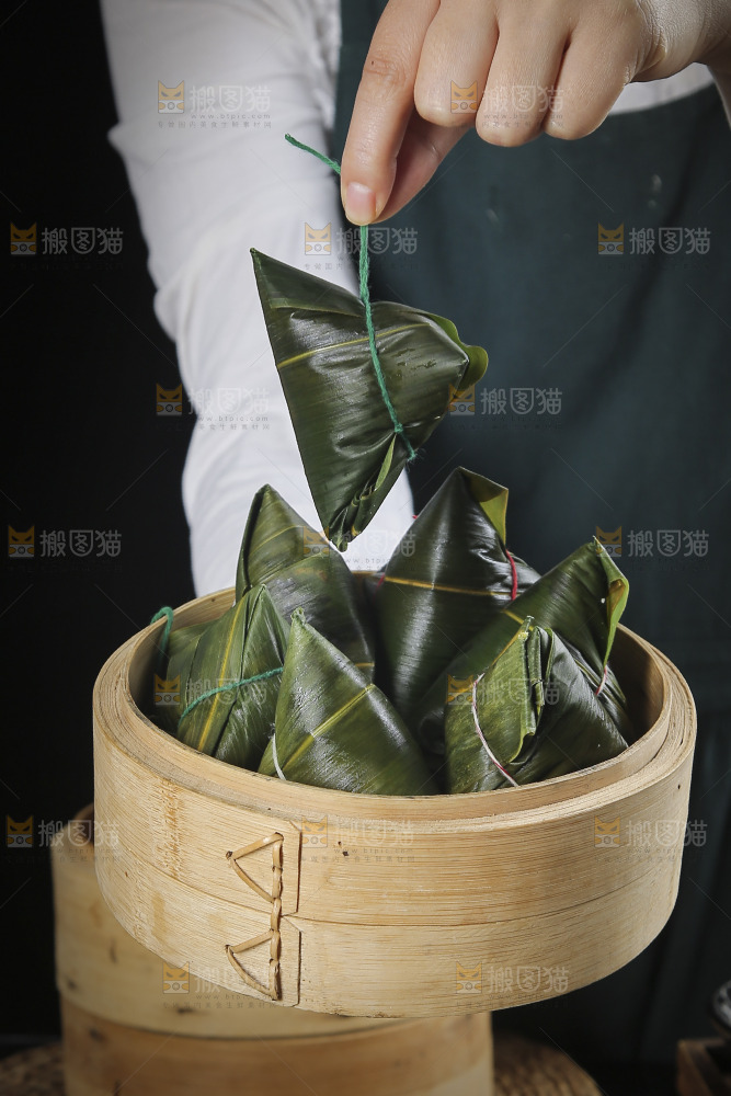 手里端着粽子