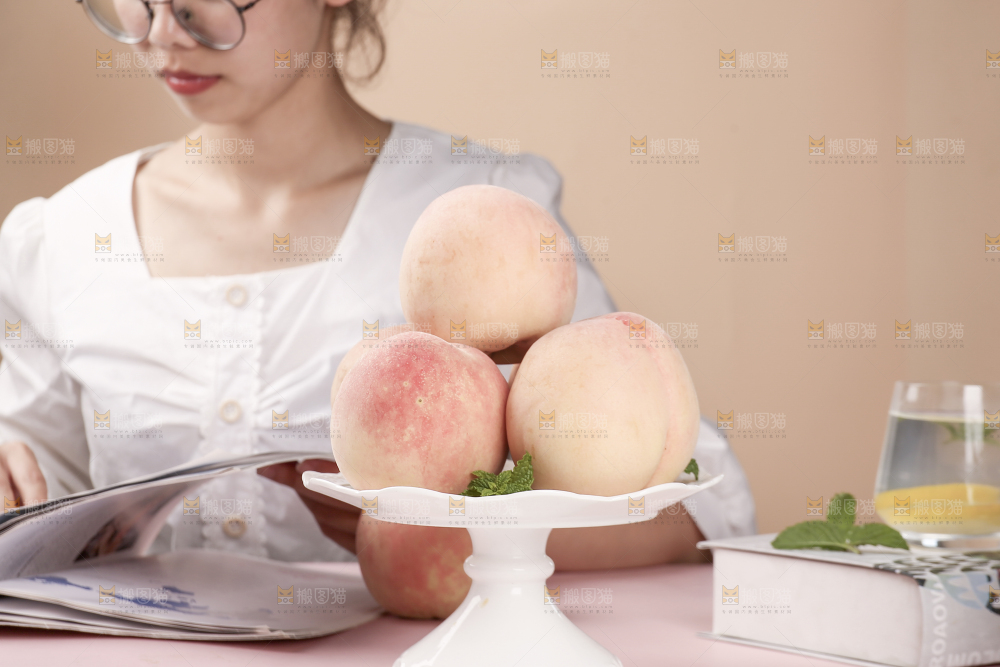 女孩边上放着一盘水蜜桃