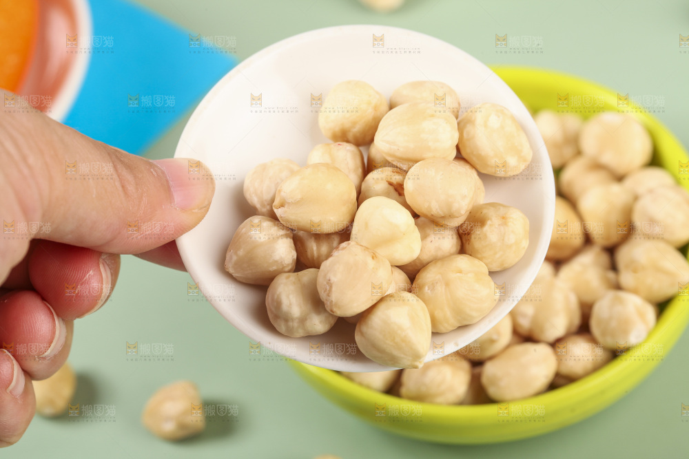 手拿着一碟榛子仁
