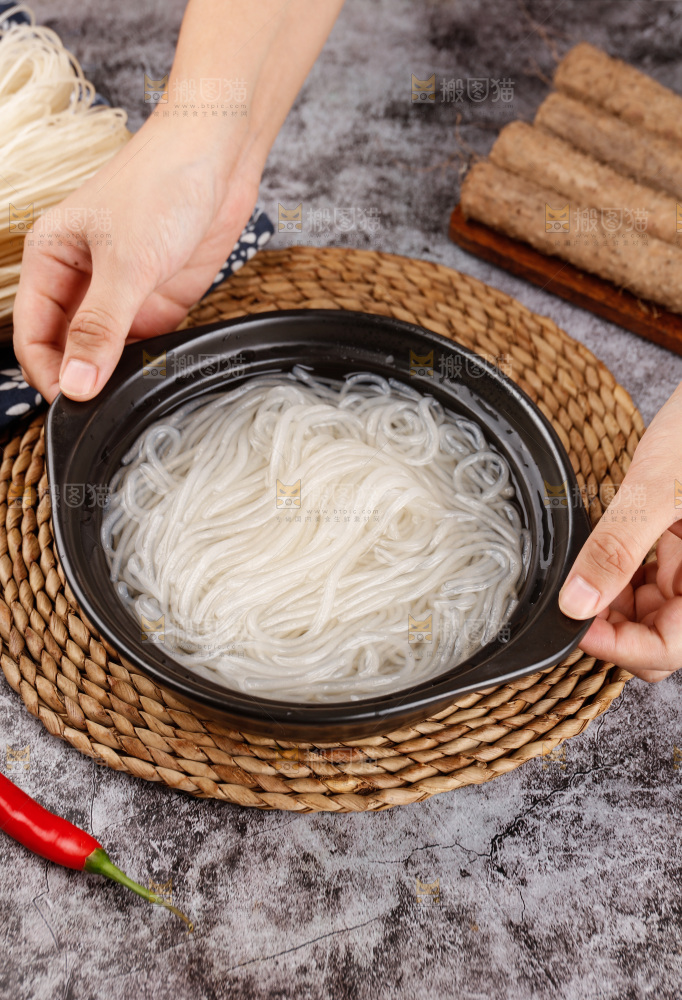 手端着一碗泡发的葛根粉条