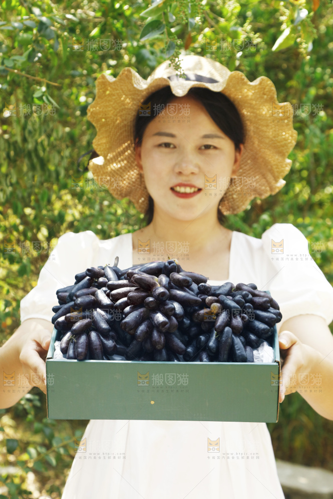 女孩拿着一盒蓝宝石葡萄