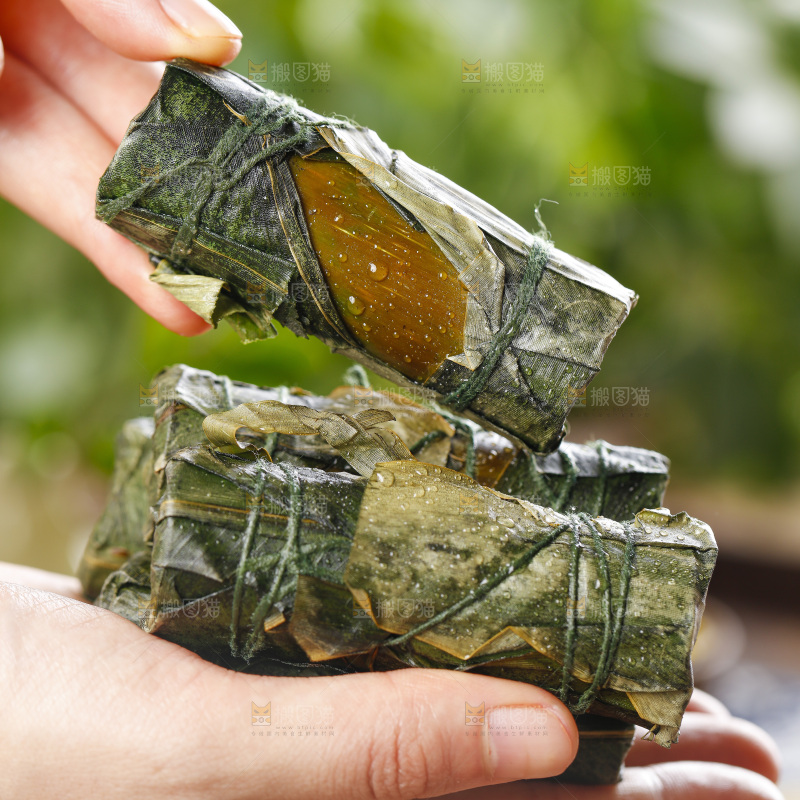 手里拿着竹筒糯米饭