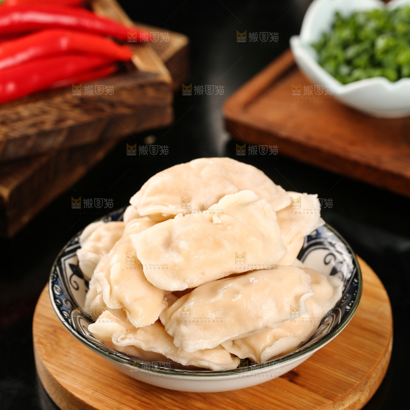 木板上放着一盘火锅饺
