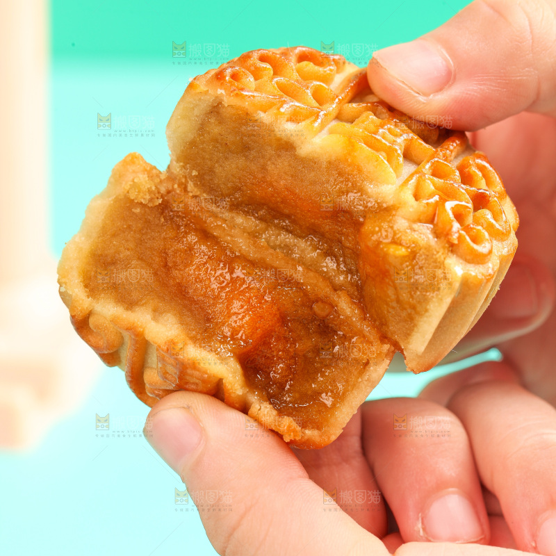 手拿着掰开的蛋黄月饼