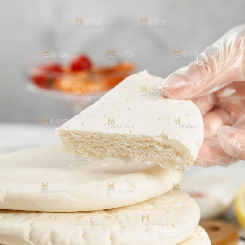 手上拿着披萨胚