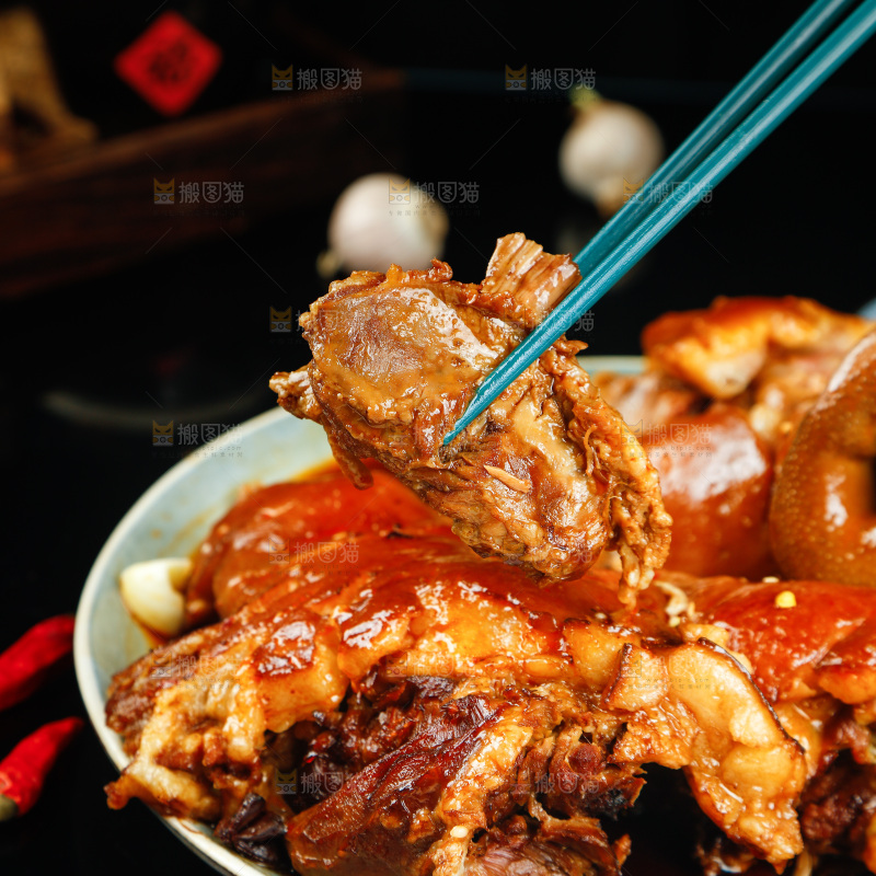 筷子上夹着卤味猪头肉