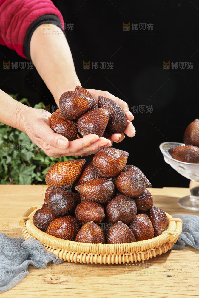 手里拿着蛇皮果